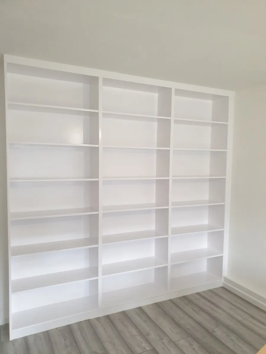 White floor-to-ceiling fitted bookcase